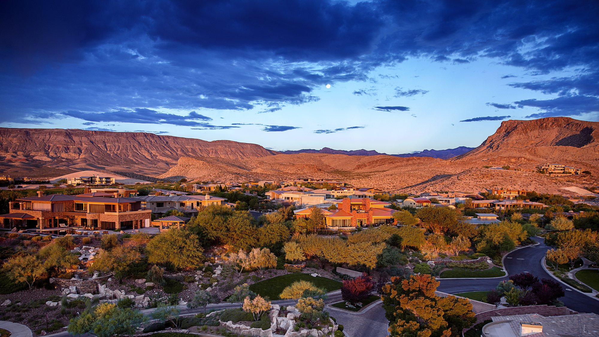 Homes below the red hills on the western rim of the valley, at last light.